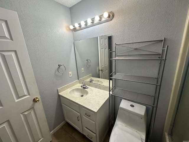 2608 Timbermist Cir, Benton, AR 72015 - bathroom featuring vanity, tile patterned flooring, a textured wall, and toilet