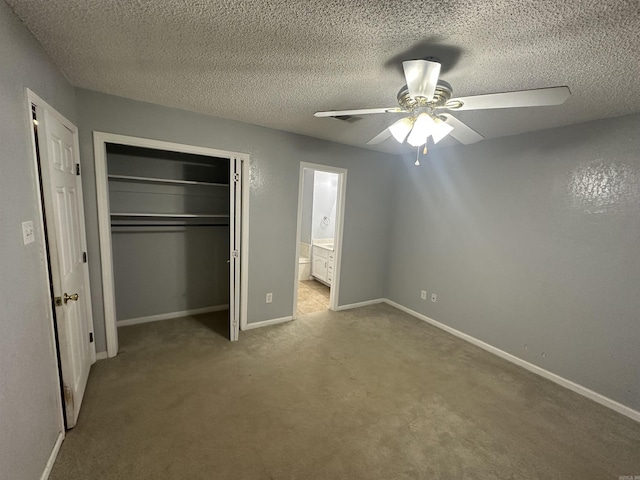 2608 Timbermist Cir, Benton, AR 72015 - unfurnished bedroom with a closet, carpet flooring, baseboards, ensuite bath, and a textured ceiling