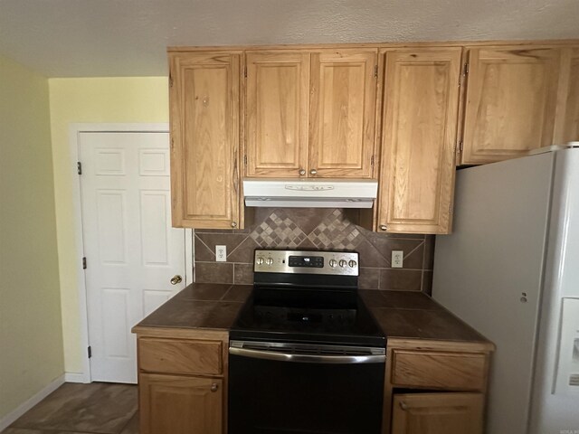 2608 Timbermist Cir, Benton, AR 72015 - kitchen with electric range oven, under cabinet range hood, white fridge with ice dispenser, and dark countertops