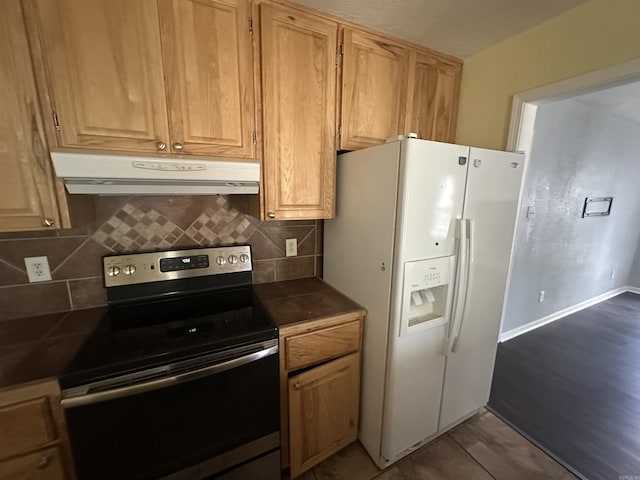 2608 Timbermist Cir, Benton, AR 72015 - kitchen with stainless steel electric range oven, ventilation hood, white refrigerator with ice dispenser, dark countertops, and backsplash