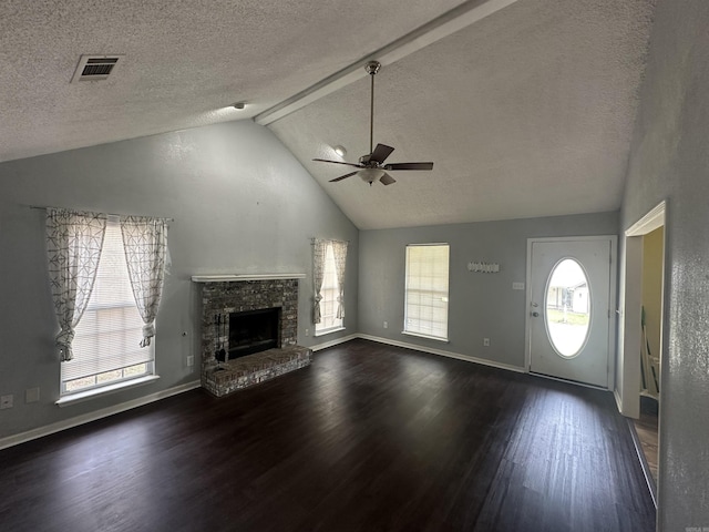 2608 Timbermist Cir, Benton, AR 72015 - unfurnished living room featuring dark wood-style flooring, ceiling fan, a textured ceiling, healthy amount of natural light, and lofted ceiling