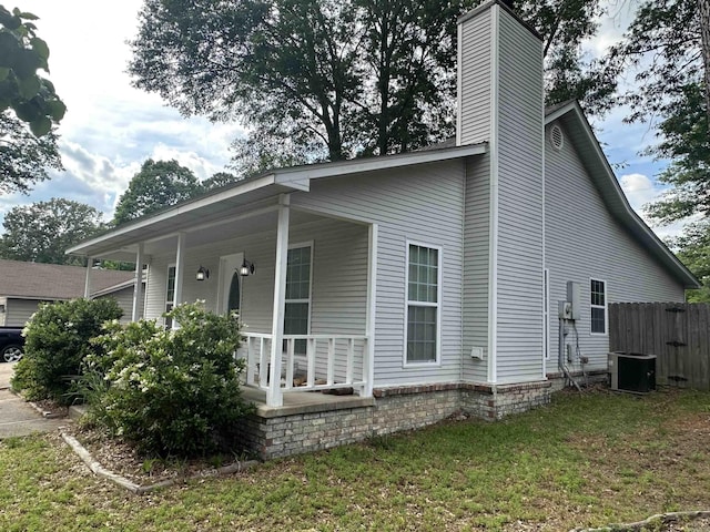 2608 Timbermist Cir, Benton, AR 72015 - view of side of home with covered porch, a chimney, and cooling unit