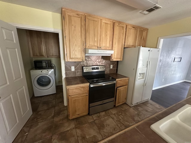 2608 Timbermist Cir, Benton, AR 72015 - kitchen featuring stainless steel range with electric stovetop, washer / clothes dryer, white refrigerator with ice dispenser, under cabinet range hood, and black microwave