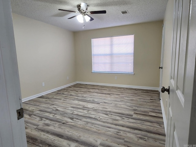 1807 Reservoir, Little Rock, AR 72227 - unfurnished room with a textured ceiling, wood finished floors, and a ceiling fan