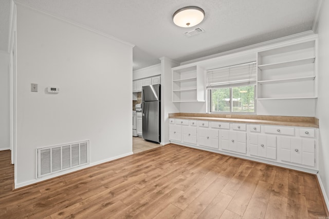 1121 Twin Pts Unit 1121C, Hot Springs, AR 71913 - kitchen featuring open shelves, freestanding refrigerator, ornamental molding, light wood-style flooring, and white cabinetry