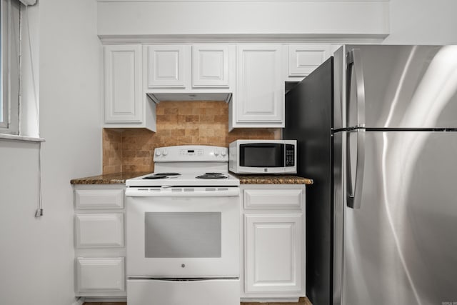 1121 Twin Pts Unit 1121C, Hot Springs, AR 71913 - kitchen with freestanding refrigerator, white range with electric cooktop, backsplash, white cabinets, and dark stone countertops