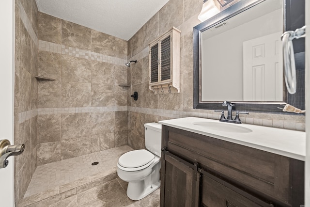 1121 Twin Pts Unit 1121C, Hot Springs, AR 71913 - bathroom with toilet, a tile shower, vanity, tile walls, and a textured ceiling