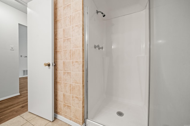 1121 Twin Pts Unit 1121C, Hot Springs, AR 71913 - bathroom featuring a shower stall, tile patterned floors, and tile walls