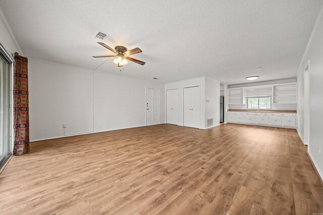 1121 Twin Pts Unit 1121C, Hot Springs, AR 71913 - unfurnished living room with ceiling fan, a textured ceiling, wood finished floors, ornamental molding, and baseboards