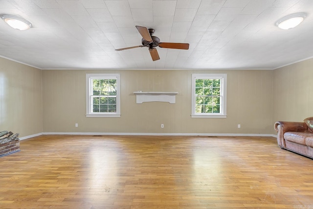 7606 Westwood Ave, Little Rock, AR 72204 - unfurnished living room featuring healthy amount of natural light, light wood-style floors, ceiling fan, and crown molding