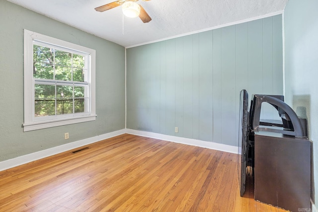 7606 Westwood Ave, Little Rock, AR 72204 - empty room with light wood-type flooring, a ceiling fan, baseboards, and a textured ceiling