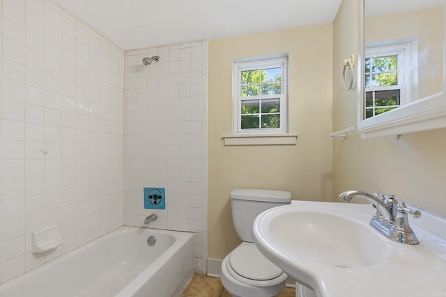 7606 Westwood Ave, Little Rock, AR 72204 - bathroom with toilet, a sink, tub / shower combination, tile patterned floors, and baseboards