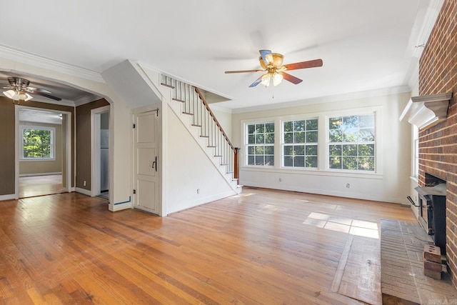 7606 Westwood Ave, Little Rock, AR 72204 - unfurnished living room featuring ceiling fan, stairs, ornamental molding, a brick fireplace, and light wood finished floors