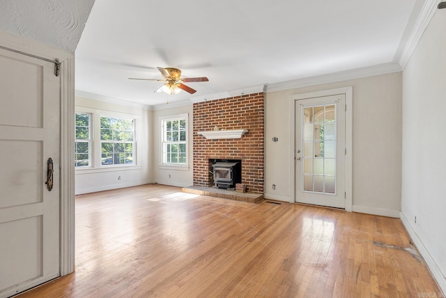 7606 Westwood Ave, Little Rock, AR 72204 - unfurnished living room featuring ceiling fan, a wood stove, crown molding, light wood finished floors, and baseboards