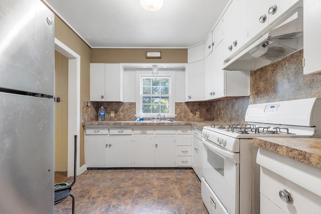 7606 Westwood Ave, Little Rock, AR 72204 - kitchen with freestanding refrigerator, white gas range, under cabinet range hood, white cabinetry, and tasteful backsplash