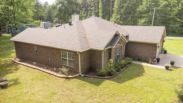 3218 Mcfadden Rd, Pine Bluff, AR 71602 - view of side of property featuring brick siding, a chimney, a yard, and a shingled roof