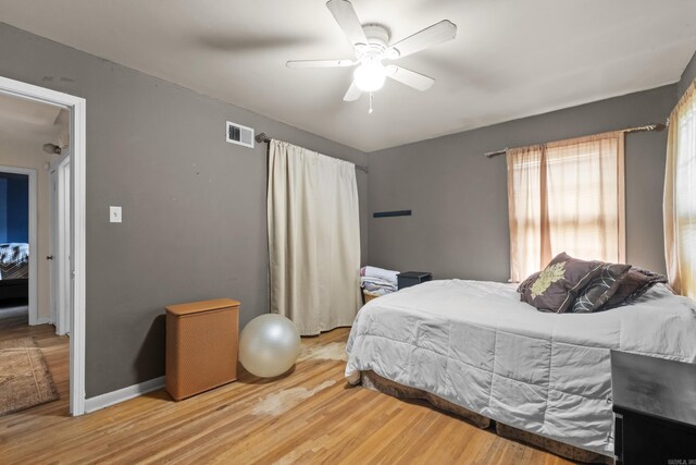 bedroom featuring wood finished floors, ceiling fan, and baseboards