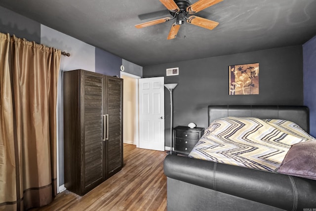 bedroom with wood finished floors, ceiling fan, and baseboards