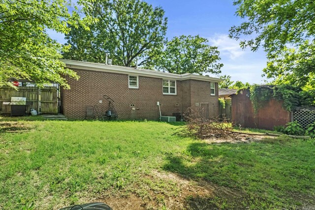 rear view of house featuring brick siding