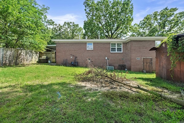 back of property featuring brick siding