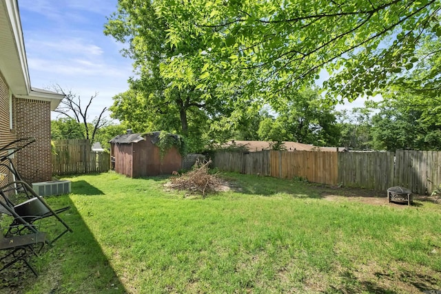 view of yard with a storage unit, an outdoor structure, and central AC