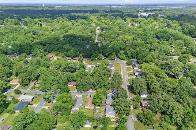 aerial overview of property's location with a heavily wooded area