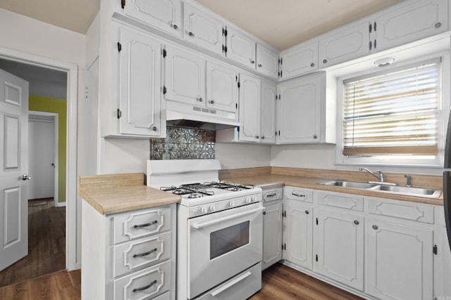 kitchen with gas range gas stove, under cabinet range hood, a sink, and white cabinetry