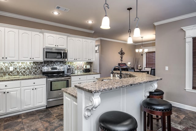 kitchen with stainless steel appliances, stone finish flooring, tasteful backsplash, a breakfast bar area, and light stone counters