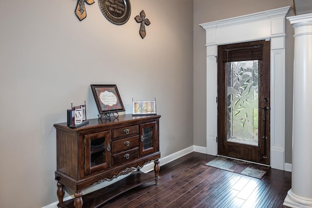 entryway with baseboards, dark wood-style floors, and decorative columns