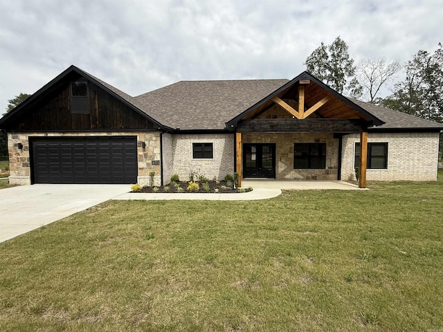 view of front of house with driveway, a front yard, french doors, and a garage