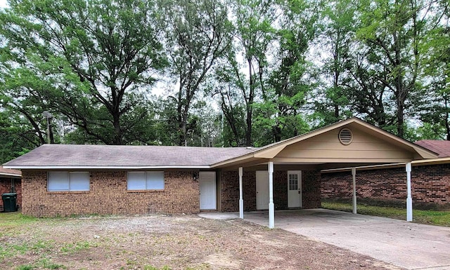 1907 Sunset, Pine Bluff, AR 71603 - single story home with driveway, brick siding, an attached carport, and roof with shingles