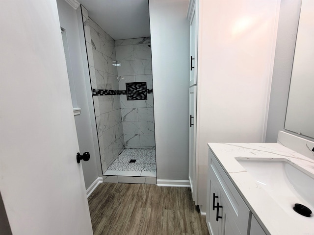 1907 Sunset, Pine Bluff, AR 71603 - bathroom with wood finished floors, a shower stall, vanity, and baseboards