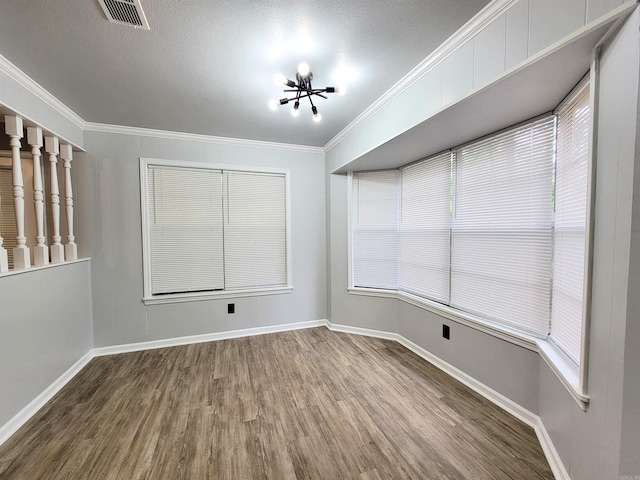 1907 Sunset, Pine Bluff, AR 71603 - unfurnished room featuring wood finished floors, ornamental molding, baseboards, a chandelier, and a textured ceiling
