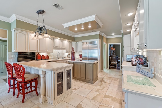 852 Rock Ledge Rd, Heber Springs, AR 72543 - kitchen with built in refrigerator, crown molding, tasteful backsplash, light countertops, and a peninsula