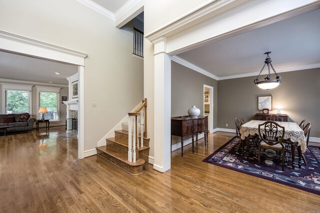 6 Frecourt Ln, Little Rock, AR 72223 - dining room with ornamental molding, wood finished floors, stairs, baseboards, and a fireplace