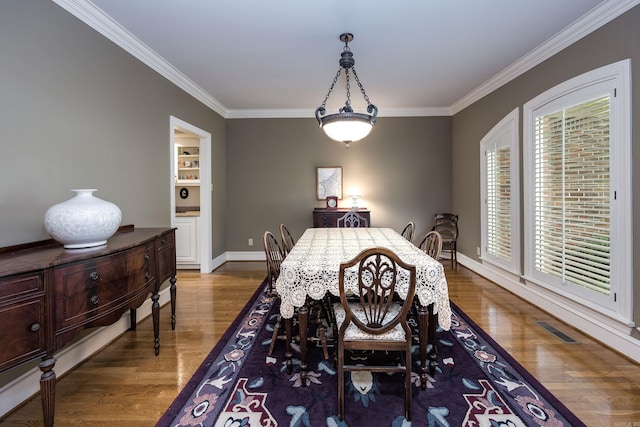 6 Frecourt Ln, Little Rock, AR 72223 - dining room with ornamental molding, wood finished floors, and baseboards