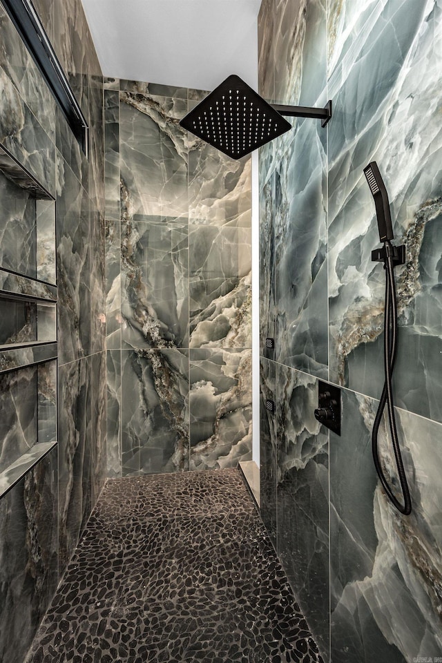 full bathroom featuring a marble finish shower