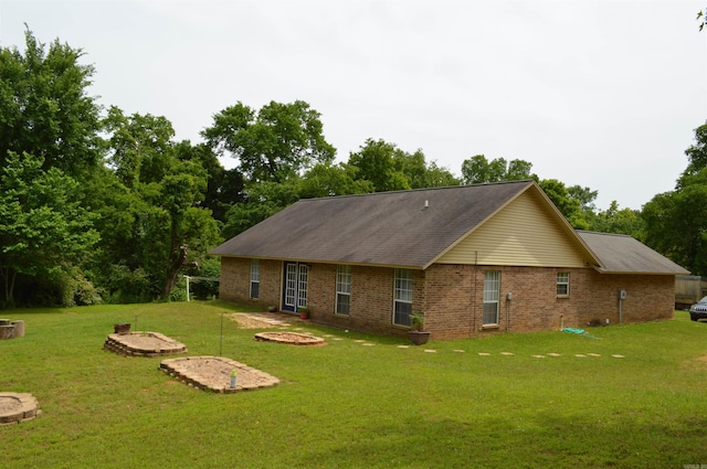 1059 Piney Rd, De Queen, AR 71832 - rear view of house with a yard, brick siding, and a fire pit