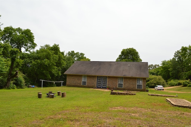 1059 Piney Rd, De Queen, AR 71832 - rear view of property with a yard and brick siding