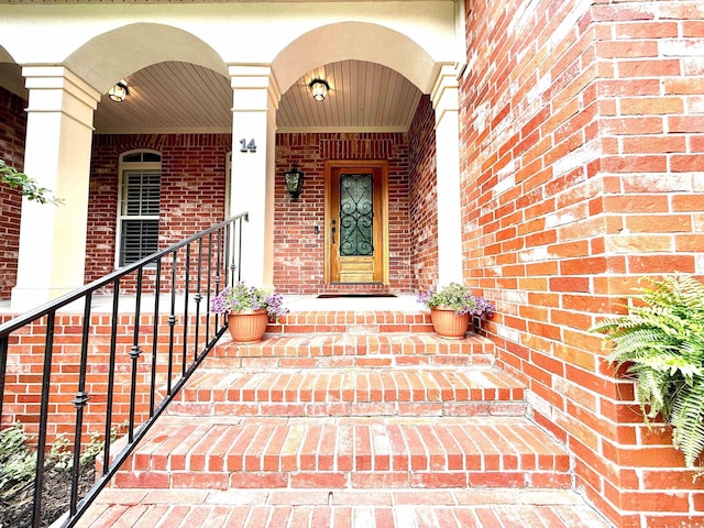 14 Windrush Pt, Little Rock, AR 72211 - doorway to property featuring brick siding and covered porch