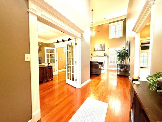 14 Windrush Pt, Little Rock, AR 72211 - hallway featuring crown molding, light wood-style flooring, baseboards, french doors, and a high ceiling