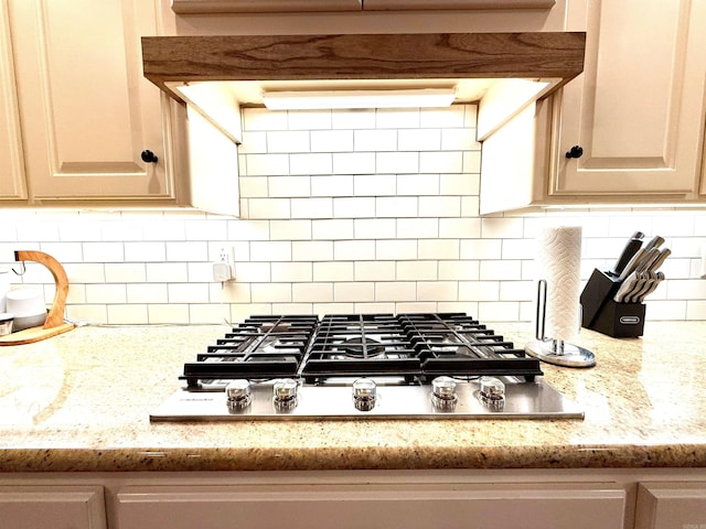 14 Windrush Pt, Little Rock, AR 72211 - kitchen with stainless steel gas cooktop, backsplash, and light stone countertops