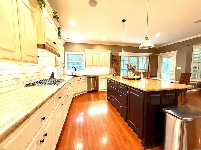 14 Windrush Pt, Little Rock, AR 72211 - kitchen featuring appliances with stainless steel finishes, wood-type flooring, dark brown cabinets, backsplash, and light stone countertops
