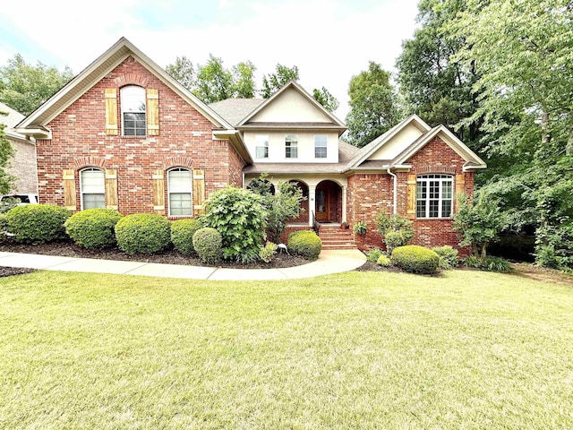 14 Windrush Pt, Little Rock, AR 72211 - view of front of property featuring brick siding, a front yard, and a shingled roof