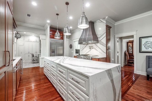 12 Darro Way, Hot Springs Village, AR 71909 - kitchen featuring stainless steel built in refrigerator, ornamental molding, wall chimney exhaust hood, dark wood-style flooring, and light stone countertops