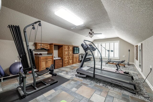 12 Darro Way, Hot Springs Village, AR 71909 - exercise area featuring lofted ceiling, a ceiling fan, a textured ceiling, a textured wall, and stone tile floors