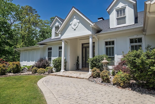 12 Darro Way, Hot Springs Village, AR 71909 - view of front of property featuring stucco siding, roof with shingles, and a front yard