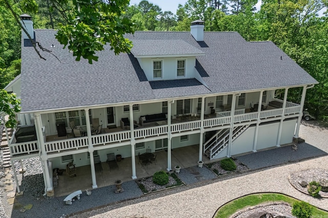 12 Darro Way, Hot Springs Village, AR 71909 - back of property featuring a shingled roof, a chimney, a patio area, stucco siding, and stairway