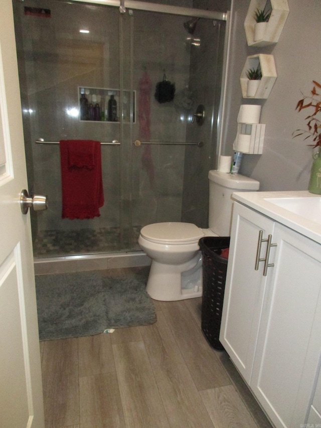 4005 Arapaho Trl, Little Rock, AR 72209 - full bathroom with toilet, vanity, wood finished floors, and a shower stall
