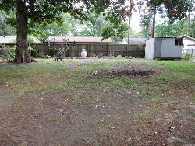 4005 Arapaho Trl, Little Rock, AR 72209 - fenced backyard featuring a storage unit and an outdoor structure